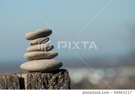 stone balance on wooden fence stone balance on wooden fence 48463217