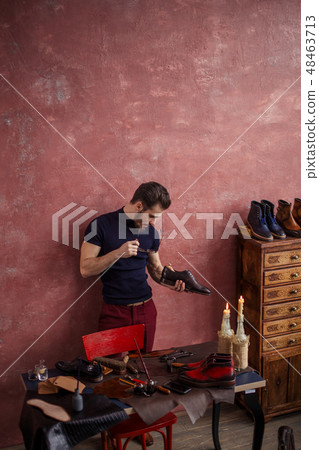 young cobber checking the insole of stylish footwear 48463713