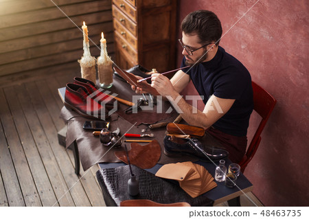 awesome master repairing old shoes 48463735