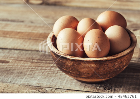 Bowl of raw chicken eggs 48463761