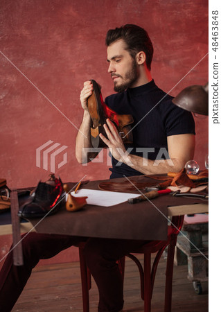 hardworking man enjoys his work in the workshop hardworking man enjoys his work in the workshop 48463848