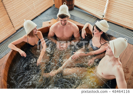 Group of caucasian diverse friends enjoying jacuzzi in hotel spa Group of caucasian diverse friends enjoying jacuzzi in hotel spa 48464116