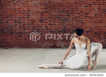 fashion ballerina strethcing her toes during workout fashion ballerina strethcing her toes during workout 48465668