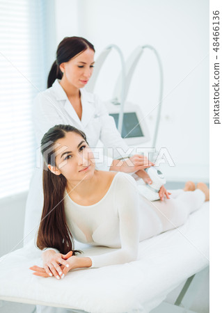 Brunette happy woman enjoying LPG massage at the beauty parlour. 48466136