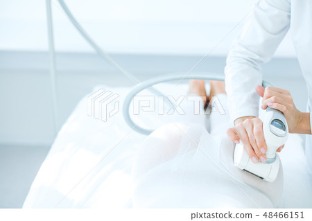 Woman in white suit getting LPG procedure , body contouring treatment in clinic. Woman in white suit getting LPG procedure , body contouring treatment in clinic. 48466151