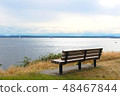 Park Bench by blue sea and sky view 48467844