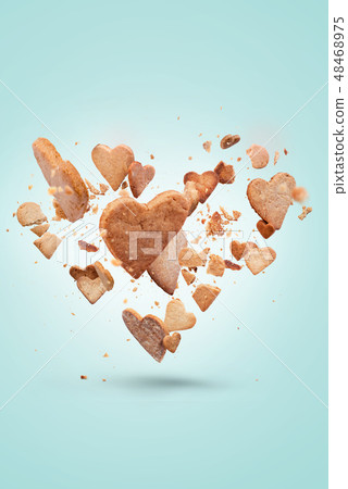 Card with flying crisp biscuit in shape of heart 48468975