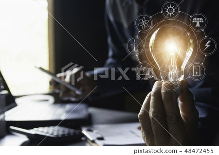 Hand of male holding a light bulb and copy space Hand of male holding a light bulb and copy space 48472455