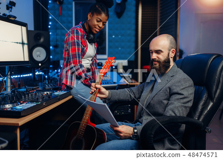 Male and female musicians, sound recording studio 48474571