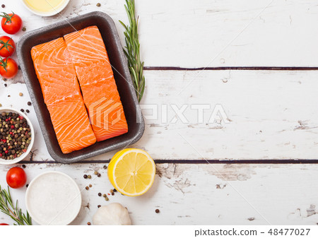 Plastic container with fresh salmon slice with oil Plastic container with fresh salmon slice with oil 48477027