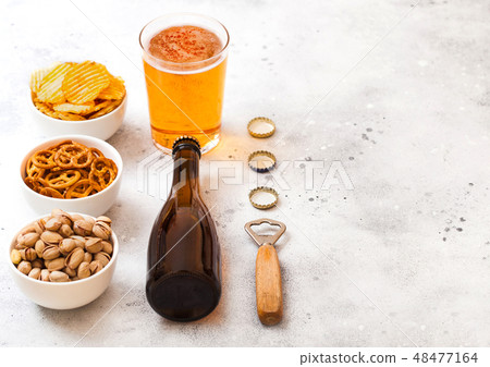Glass and bottle of craft lager beer with snack Glass and bottle of craft lager beer with snack 48477164