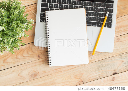 Blank notebook with and pencil on laptop Blank notebook with and pencil on laptop 48477168