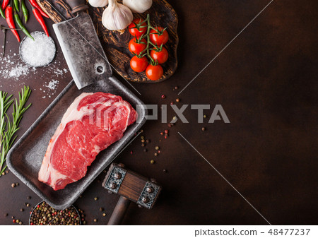 Raw sirloin beef steak in plastic tray with salt  48477237