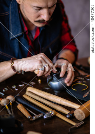 Jack of all trades. serious guy preparing jewellery for cliens 48477303