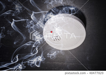Smoke alarm in the smoke of a fire 48477820