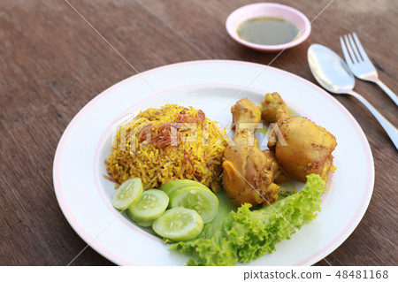 Muslim yellow rice with chicken in a white plate  48481168