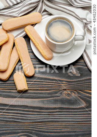 Italian Savoiardi ladyfingers Biscuits and cup of coffee on wooden backgound 48482030