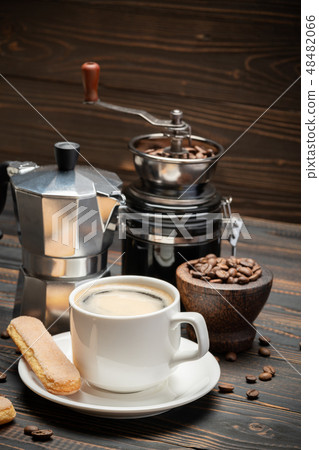 Cup of coffee with coffe maker on wooden backround Cup of coffee with coffe maker on wooden backround 48482066