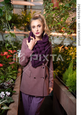 Beautiful good looking woman wearing a violet scarf Beautiful good looking woman wearing a violet scarf 48482662