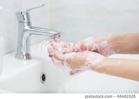 Washing hands with soap with water. 48482826