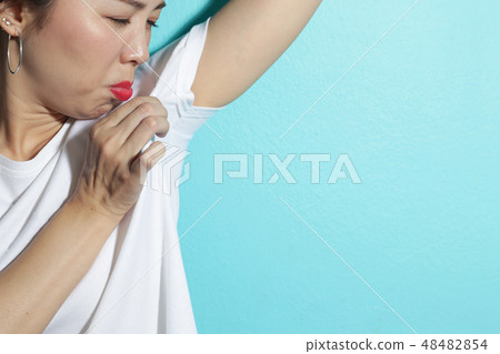 Woman pointing at wet stain under arm. 48482854