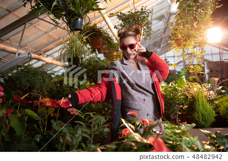 Nice good looking woman wearing a red jacket Nice good looking woman wearing a red jacket 48482942