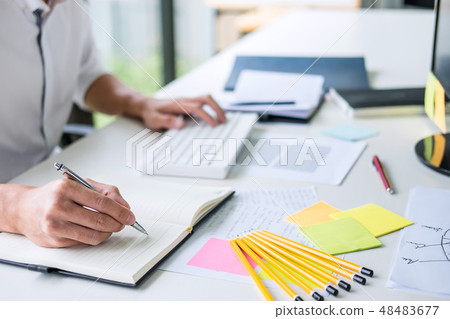 Businessman working writing making note business plan and graphi Businessman working writing making note business plan and graphi 48483677