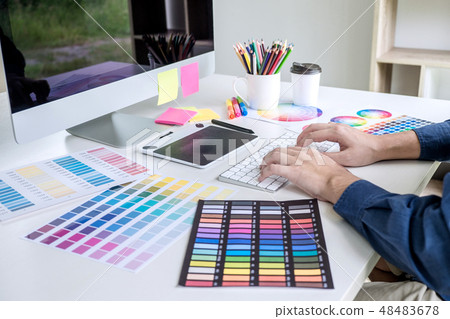 Image of male creative graphic designer working on color selecti 48483678