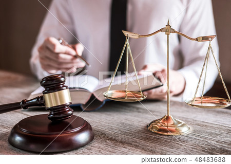 Male lawyer or judge working with Law books, gavel and balance, 48483688