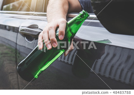 Close up of bottle, Young asian man drives a car with drunk a bo 48483788