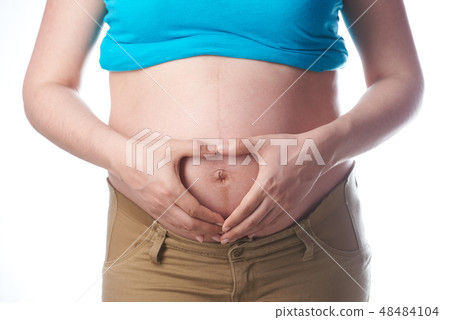 Shape heart hands on pregnant tummy 48484104
