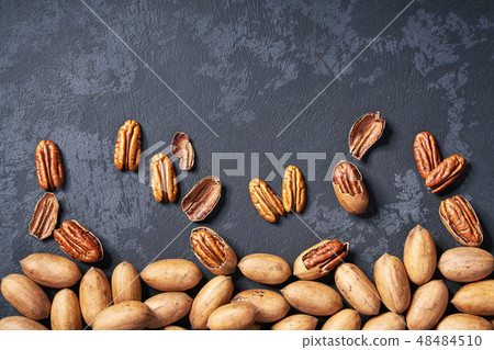 Pecan nuts on black table, with copy space. Pecan nuts on black table, with copy space. 48484510