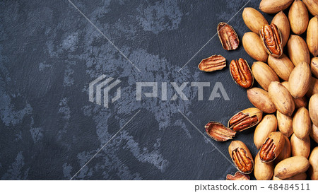 Pecan nuts on black table, with copy space. Pecan nuts on black table, with copy space. 48484511