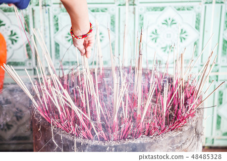 Burning incense in incense pot with white smoke Burning incense in incense pot with white smoke 48485328