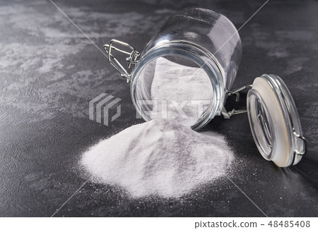Jar of baking soda on a black background. Jar of baking soda on a black background. 48485408