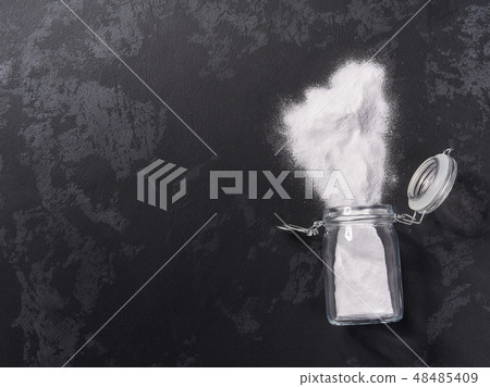 Jar of baking soda on a black background.Flat lay 48485409