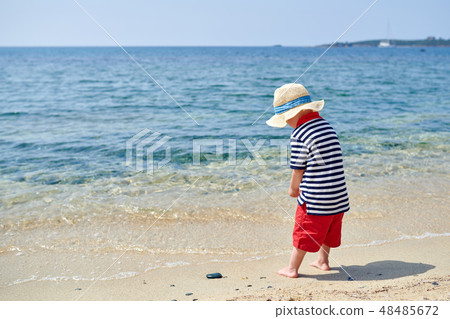 Toddler boy on beach 48485672