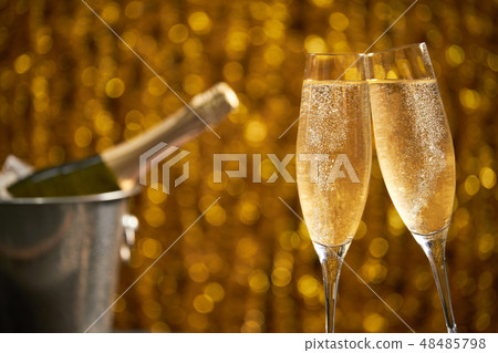 Two glasses of champagne with lights in background 48485798