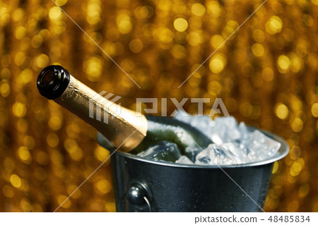 open bottle of champagne in a bucket with ice open bottle of champagne in a bucket with ice 48485834