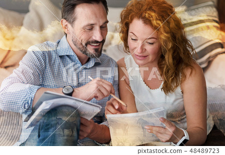 Kind attentive man helping his girlfriend to check her work 48489723