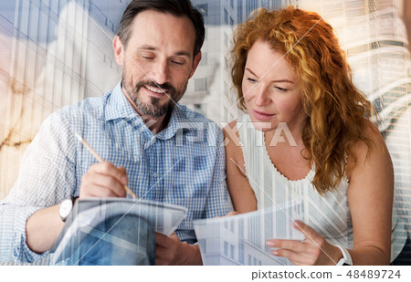 Attentive curious woman looking at the notes of her boyfriend 48489724