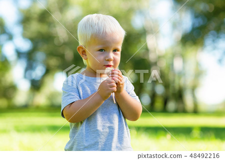 Shy cute child looking at you attentively 48492216