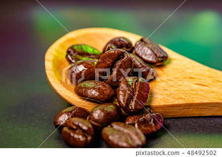 Coffee beans cut with wooden spoons 48492502
