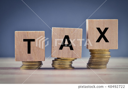 Wood cube with word TAX and stacking coin Wood cube with word TAX and stacking coin 48492722
