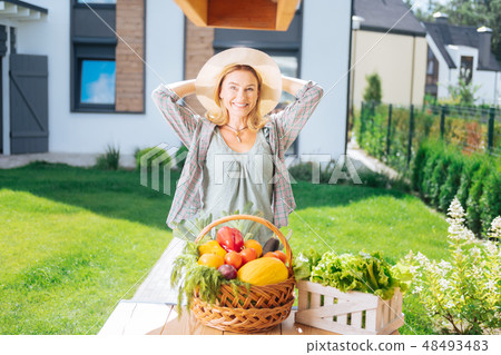 Beaming family woman cooking garden salad out from fresh vegetables outside 48493483