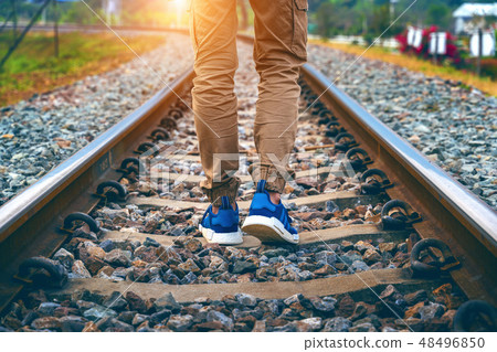 Feet of male walking on railroad. Travel concept. Feet of male walking on railroad. Travel concept. 48496850