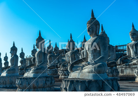 a lot of big Buddha statues in blue sky 48497069
