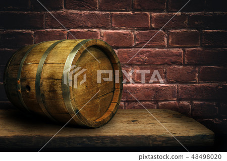 Wooden barrel and worn old table of wood. 48498020