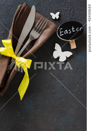 Festive table setting for holiday Easter dinner on dark table. Festive table setting for holiday Easter dinner on dark table. 48499684