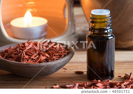 A bottle of red sandalwood essential oil A bottle of red sandalwood essential oil 48501731